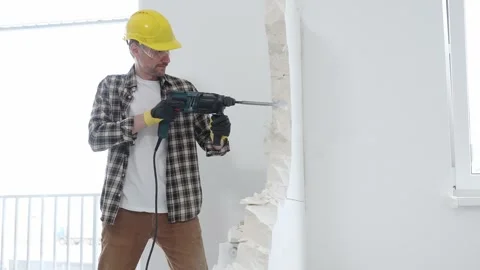 Man construction worker wearing beige checkered shirt , yellow hard hat and Stock Footage 310402563