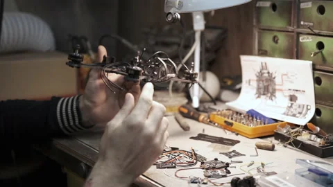 Man constructs a copter in a workshop Stock-Footage 139538563