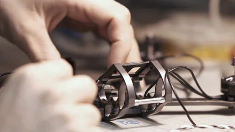 Man constructs a FPV copter in a workshop. Stock Footage 139538921