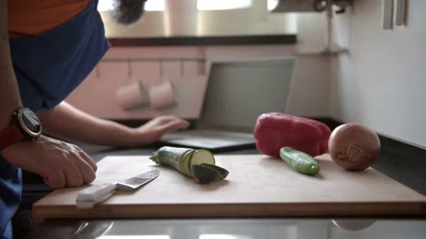 Man consulting a recipe on the computer at kitchen Stock-Footage 136410410