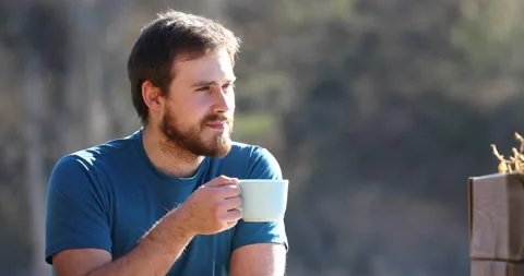 Man contemplating and drinking coffee outdoors Stock Footage 186191523