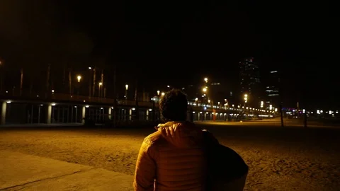 Man contemplating the city at night Stock Footage 104123556