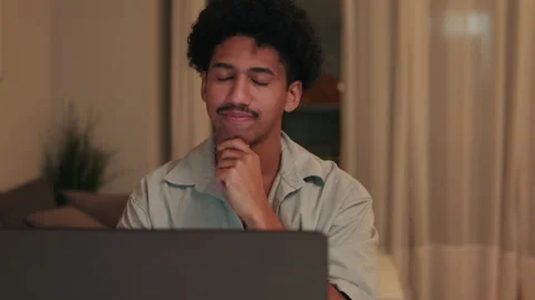 Man Contemplating at Laptop Working From Home Stock Footage 325633577