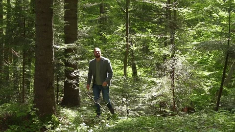 Man contemplating the light inside forest. Nature calmness Stock Footage 94099445