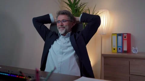 Man is contentedly enjoying the end of the working day. Stock Footage 268328145
