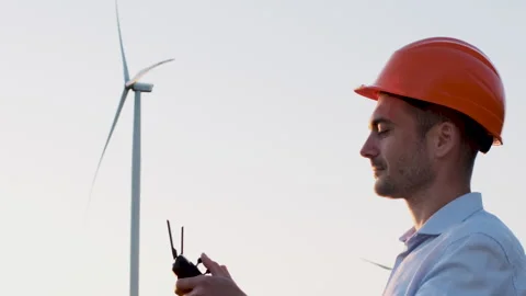 Man with a control panel, background of a field of wind turbines Video stock 135010616
