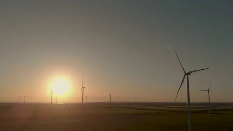 Man with a control panel, background of a field of wind turbines Stockbeeldmateriaal 135010946