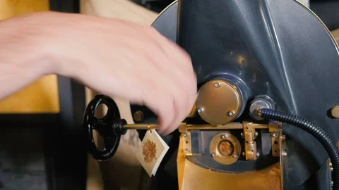 A man controling roasting coffee Stock Footage 92542497