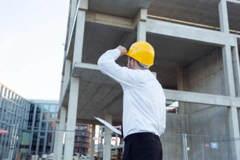 Man Controlling Building. Builder making marks in Clipboard. House Building Stock Photos