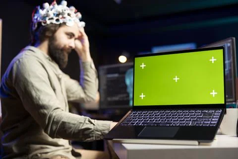 Man controlling computer functions using mind, helped by mockup notebook Stock Photos