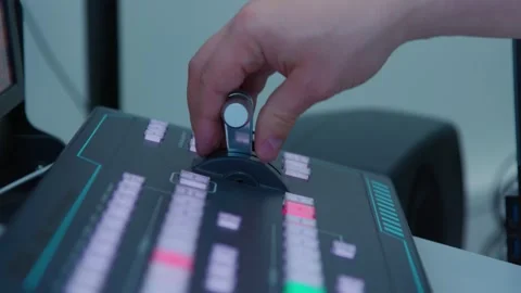 A man controlling a control panel with a green and red buttons Видео 334768157