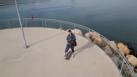 A man is controlling a drone flying around him Stock Footage 255642027