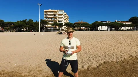 Man controlling drone with transmitter on the coast. Stock Footage 88654092