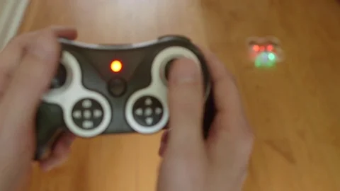 Man Controlling Personal Drone Quadcopter Toy Startup and Takeoff Indoors Stock Footage 75836402
