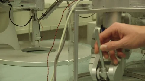 Man Controlling Robot Arm Through A Small Joystick Video stock 126701252