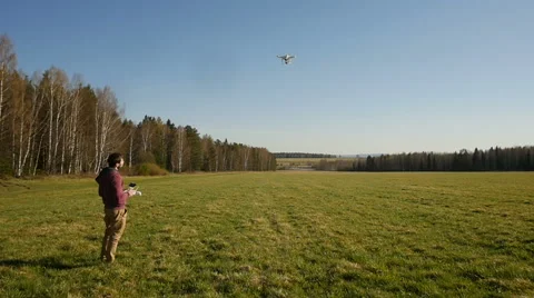 A man controls a drone in field Stock Footage 62961053