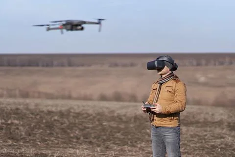A man controls a drone in special FPV goggles Stock Photos