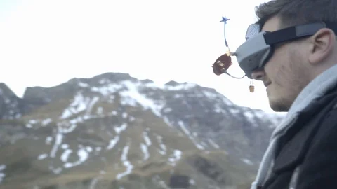 Man controls a drone through a remote control and glasses. Stock Footage 120934185