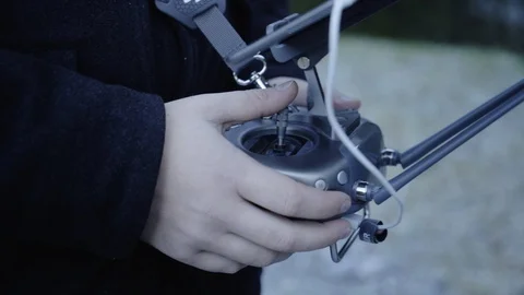 Man controls a drone through a remote control and glasses. Stock Footage 120935704