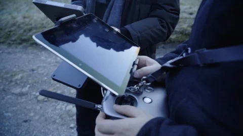 Man controls a drone through a remote control and glasses. Stock Footage 120935728