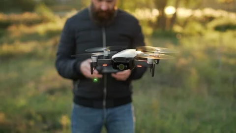 Man controls drones in vicinity of himself 스톡 동영상 95813042