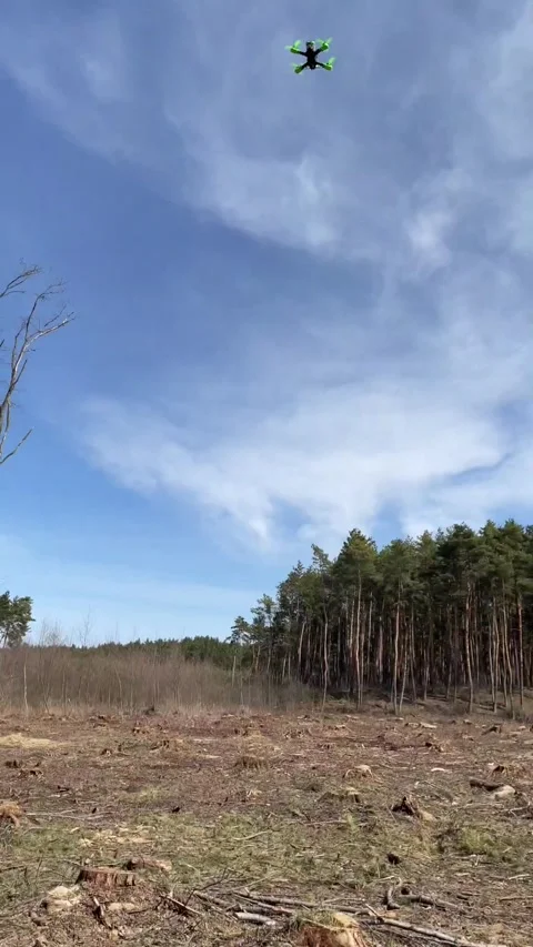 Man controls the FPV drone. an fpv drone flying trough a tree Stock Footage 303243814