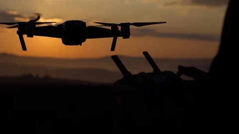 A man controls his quadcopter with the help of a remote control Stock Footage 119712099