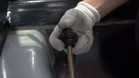 A man controls the levers of mounted attachment on agricultural machinery Stock Footage 128679390
