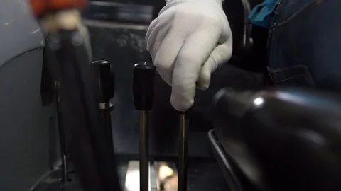 A man controls the levers of mounted attachment on agricultural machinery Stock Footage 128679698