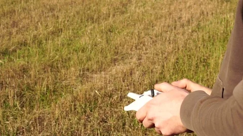 Man controls the quadrocopter. remote control in hand Stock Footage 81319733