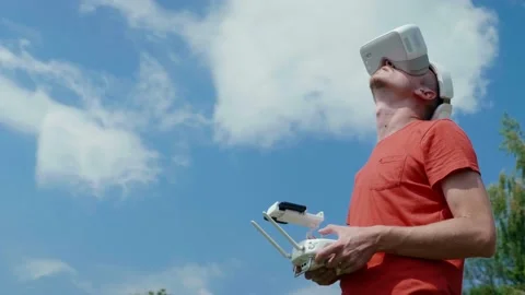 Man controls a quadrocopter through a remote control Stock Footage 130238125