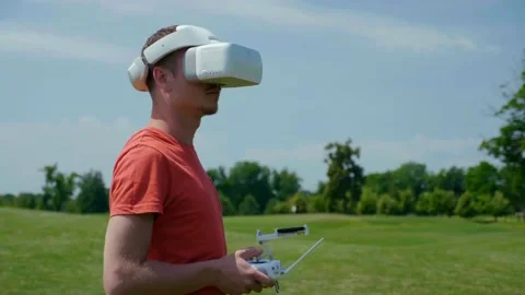Man controls a quadrocopter through a remote control Stock Footage 130775402