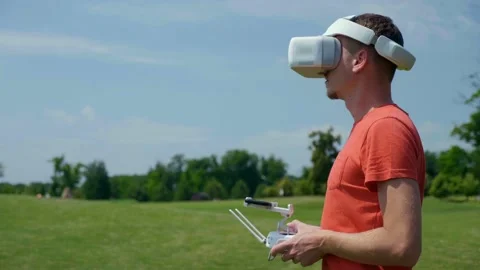 Man controls a quadrocopter through a remote control Stock Footage 131071533