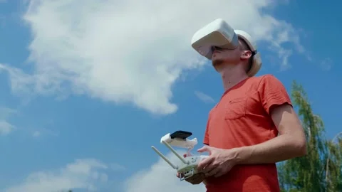 Man controls a quadrocopter through a remote control Stock Footage 132381577