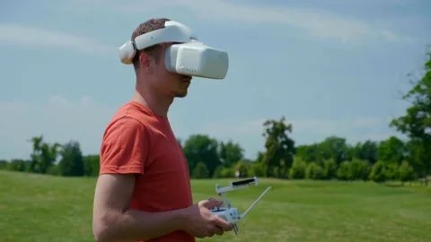 Man controls a quadrocopter through a remote control Stock Footage 132381627