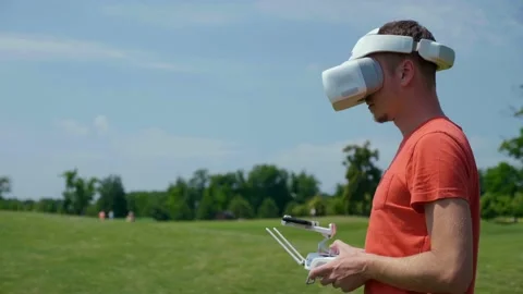 Man controls a quadrocopter through a remote control Stock Footage 132974634