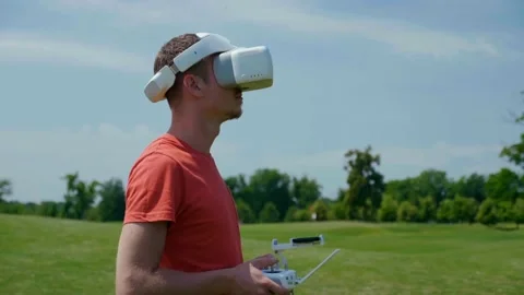 Man controls a quadrocopter through a remote control Stock Footage 133485503