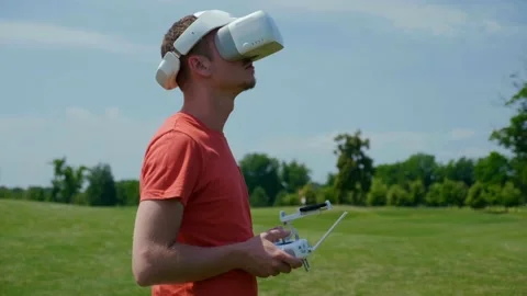 Man controls a quadrocopter through a remote control Stock Footage 134601775