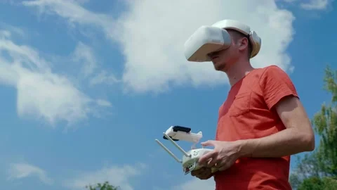 Man controls a quadrocopter through a remote control Stock Footage 135299655