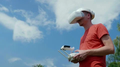 Man controls a quadrocopter through a remote control Stock Footage 135641989