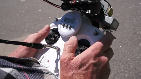 Man controls quadrocopter. View on remote control. Stock Footage 37915757