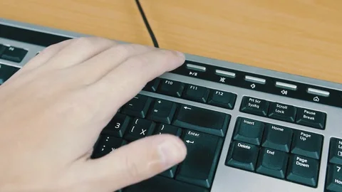 The man controls the sound on a computer keyboard. Stock Footage 70170485