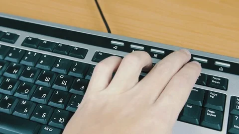 The man controls the sound on a computer keyboard. Stock Footage 70171592