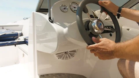 Man controls the steering wheel of the boat Stock Footage 115836627