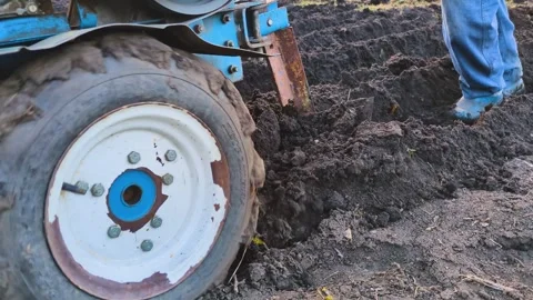 A man controls a tillerblock Stock Footage 303950006