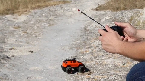 Man controls a toy car with a remote control joystick Video stock 120416922