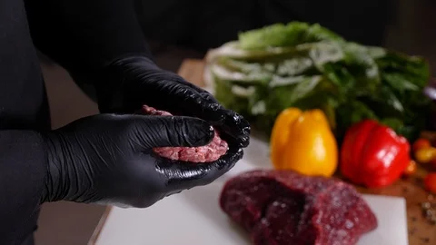 Man cooker form meat ham cutlet for a burger. Stock Footage 94034740