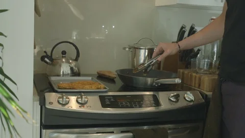 Man Cooking Breaded Fish On Stove Top Stock-Footage 121287458