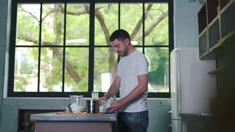 The man is cooking a breakfast and smiling Stock Footage 79108484