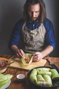 Man Cooking Cabbage Rolls Stuffed with Ground Meat Stock Photos